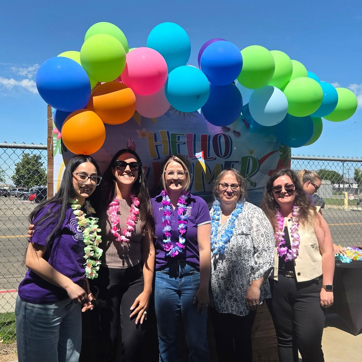 teachers standing in front of balloons